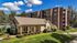 Charming apartment community with a modern building and cozy clubhouse, surrounded by lush greenery and vibrant landscaping.