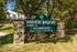 Inviting entrance sign of Wyntre Brooke Apartments surrounded by lush greenery and elegant stone pillars.