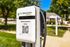 Modern EV charging station at Wyntre Brooke 2, nestled in a vibrant neighborhood with lush greenery.