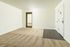 Bright and inviting living space with plush carpet and elegant entrance, ideal for modern living.