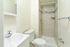 Bright and modern bathroom featuring a spacious walk-in shower with elegant tilework, stylish vanity, and sleek fixtures.