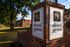 Charming Elwood Gardens Apartments entrance with elegant signage surrounded by lush greenery and classic architecture.