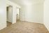 Bright and spacious room with plush carpeting and open closet space, perfect for creating a cozy personal retreat.