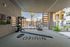Stylish outdoor fitness area featuring modern gym equipment and scenic views of a luxurious apartment community.