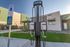 Modern apartment complex featuring eco-friendly EV charging stations and inviting future resident parking.