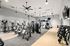 Modern fitness center equipped with state-of-the-art treadmills, weightlifting machines, dumbbells, and sleek interior design.