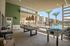 Luxurious outdoor recreation area featuring a billiards table, modern seating, and a crystal-clear pool with palm tree views.