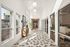 Sleek and bright hallway with modern decor, patterned floor tiles, large windows, and stylish lighting.