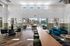Spacious and elegant lounge area featuring a modern design with plush seating, large windows, and access to a sunny poolside view.
