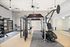 Modern fitness center equipped with state-of-the-art gym machines, a treadmill, and ample space for workouts, ideal for an active lifestyle.