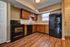 kitchen with hardwood floors and black appliances at Silver Springs Apartments in Springfield MO