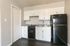 kitchen with white cabinets and black appliances at Eastview Apartments in Springfield MO