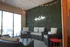Chic outdoor seating area with wicker furniture, decorative string lights, and a stylish wall art inscription.