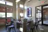 Contemporary office space with a wooden desk, chairs, and large windows providing natural light.
