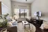 Cozy living room with chic decor, featuring a plush gray sofa, modern armchair, and sleek TV setup. Natural light floods through large windows adjacent to stylish indoor plants and neutral-toned curtains.