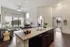 Chic open-concept apartment kitchen and living space with modern lighting, elegant countertops, and cozy decor.