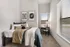 Cozy bedroom showcasing modern decor, plush bed, and natural light streaming through large windows.