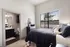 Bright and airy bedroom with plush bedding, large window view, and ensuite bathroom for a serene and convenient living experience.