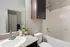 Elegant bathroom with modern decor featuring a granite countertop, stylish sink, and a relaxing bathtub.