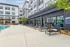 Modern apartment complex featuring a luxurious poolside area with stylish lounge chairs and a chic outdoor patio.
