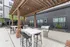 Chic outdoor space featuring a modern pergola, sleek stainless steel grills, and stylish seating, perfect for entertaining.