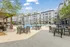 Luxurious apartment complex with a sparkling pool and stylish outdoor seating, perfect for relaxation and social gatherings.