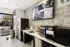 Chic indoor cafe area with modern appliances, stylish countertops, and a large window revealing a vibrant outdoor space.
