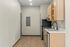 Modern apartment kitchen with sleek cabinetry, stainless steel appliances, and elegant wood floors.