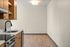 Modern kitchen with sleek wooden cabinets, integrated appliances, and elegant lighting, offering abundant space and style.