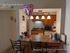Charming apartment kitchen with modern lighting, breakfast bar, and cozy ambiance; perfect for intimate gatherings and home-cooked meals.
