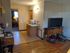 Cozy one bedroom apartment showcasing a warm living space with wood flooring, convenient kitchenette, and ample natural light.