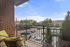 Apartment balcony near Auburn University. Inviting balcony view overlooking a charming urban landscape, featuring cozy seating and lush greenery.