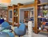 Game room and lounge at Auburn student apartments. Modern communal lounge featuring cozy seating, rich wood accents, and vibrant decor with a playful atmosphere.