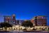 Auburn student apartments exterior at night. Elegant urban apartment complex at dusk with warm lighting and modern architecture, inviting entrance and vibrant ambiance.
