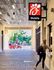 Chick-fil-A located inside 320 West Mag apartments Auburn. Modern covered walkway with distinctive fast-food signage above; vibrant outdoor view and person receiving service adds dynamic energy.