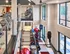 Fitness center with cardio and strength equipment at Auburn student apartments. Modern apartment gym with state-of-the-art treadmills, vibrant exercise balls, and panoramic windows offering a bright, energizing workout space.