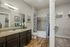 View into conventional bathroom and walk-in closet from bedroom | Urban Oaks | Conroe Apartments for Rent