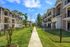 Sidewalks and grassy area between buildings at Urban Oaks | Apartments in Conroe