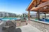 Inviting poolside area with a BBQ grill and shaded seating at a modern apartment complex.