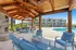 Inviting covered patio with cushioned seating overlooking our pool.