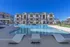 Luxurious residential complex with a stunning pool area surrounded by modern apartments.
