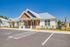 Charming modern building with inviting facade, featuring landscaped surroundings and ample parking.