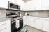 Modern kitchen with sleek stainless steel appliances, granite countertops, and crisp white cabinetry creating a fresh, inviting space.