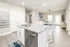 Modern open-plan apartment with a stylish kitchen island, bright living area, and elegant decor.