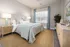 Chic and cozy bedroom with elegant decor, featuring a plush bed, soft lighting, and stylish furniture.