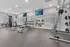 Luxurious apartment gym with modern fitness equipment, spacious layout, and well-lit interiors.