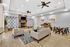 Luxurious lclubhouse with modern furniture, cozy stone fireplace, and abstract art decor.