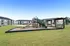 Charming apartment complex featuring a modern playground with slides and seating, ideal for families in a vibrant community.
