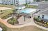 Charming apartment complex featuring a sparkling pool, elegant pergola, and cozy fire pit area surrounded by lush greenery.