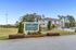 Inviting view of The Springs Luxury Apartment Homes with lush landscaping and spacious parking area.